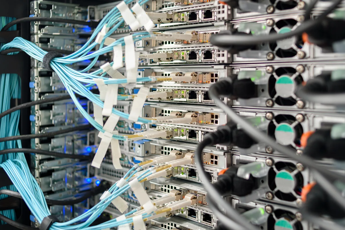 Close-up of connected servers and blue network cables
